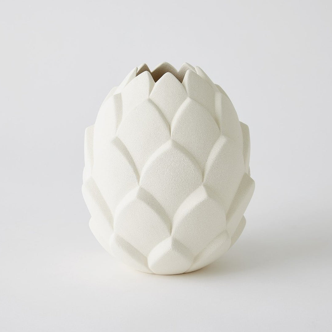 White ceramic vase shaped like an artichoke on a light gray background. Cynara Vase L District Home