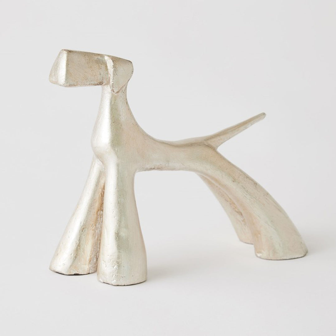 Silver metallic sculpture of a dog on a white background. Silver Leaf Sculpture Doggo S District Home 