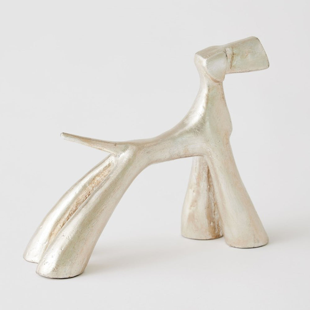 Silver metallic sculpture of a dog on a white background. Silver Leaf Sculpture Doggo S District Home 