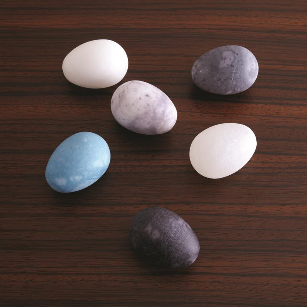 Set of six marbled stones in various colors on a light gray background. Set of 6 Assorted Alabaster Eggs District Home