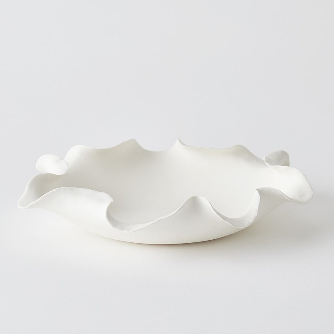 White ceramic dish with wavy design on a white background. Decorative Bowl Laurel L District Home