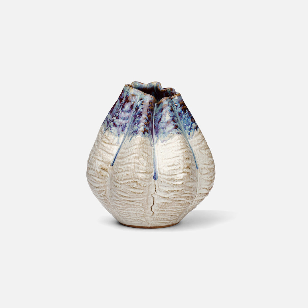 Ceramic vase with textured surface and blue accents on a white background. Ceramic Vase Miadana by District Home