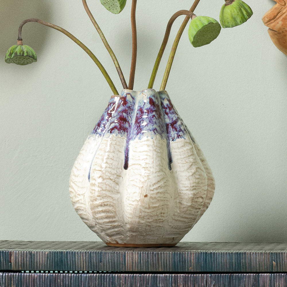 Ceramic vase with textured surface and blue accents on a white background. Ceramic Vase Miadana by District Home