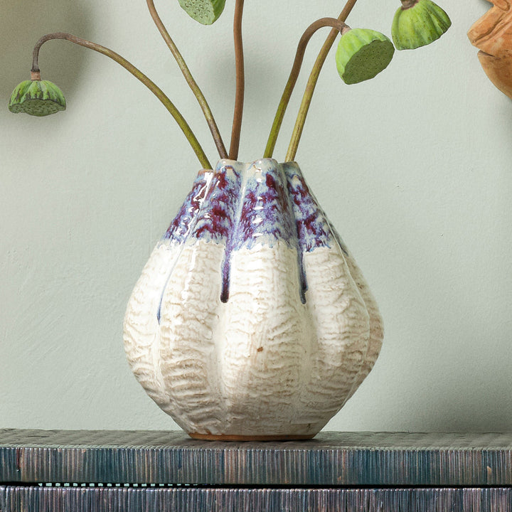 Ceramic vase with textured surface and blue accents on a white background. Ceramic Vase Miadana by District Home