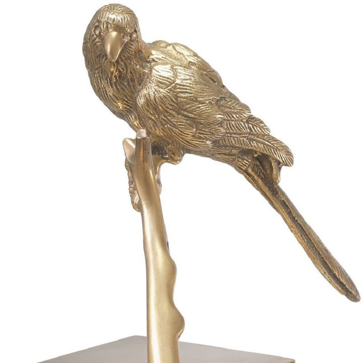 Two gold parrot sculptures on branches with clear bases on a white background. Decorative Sculpture Tweet by District Home